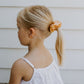 girls yellow scrunchie in blond hair