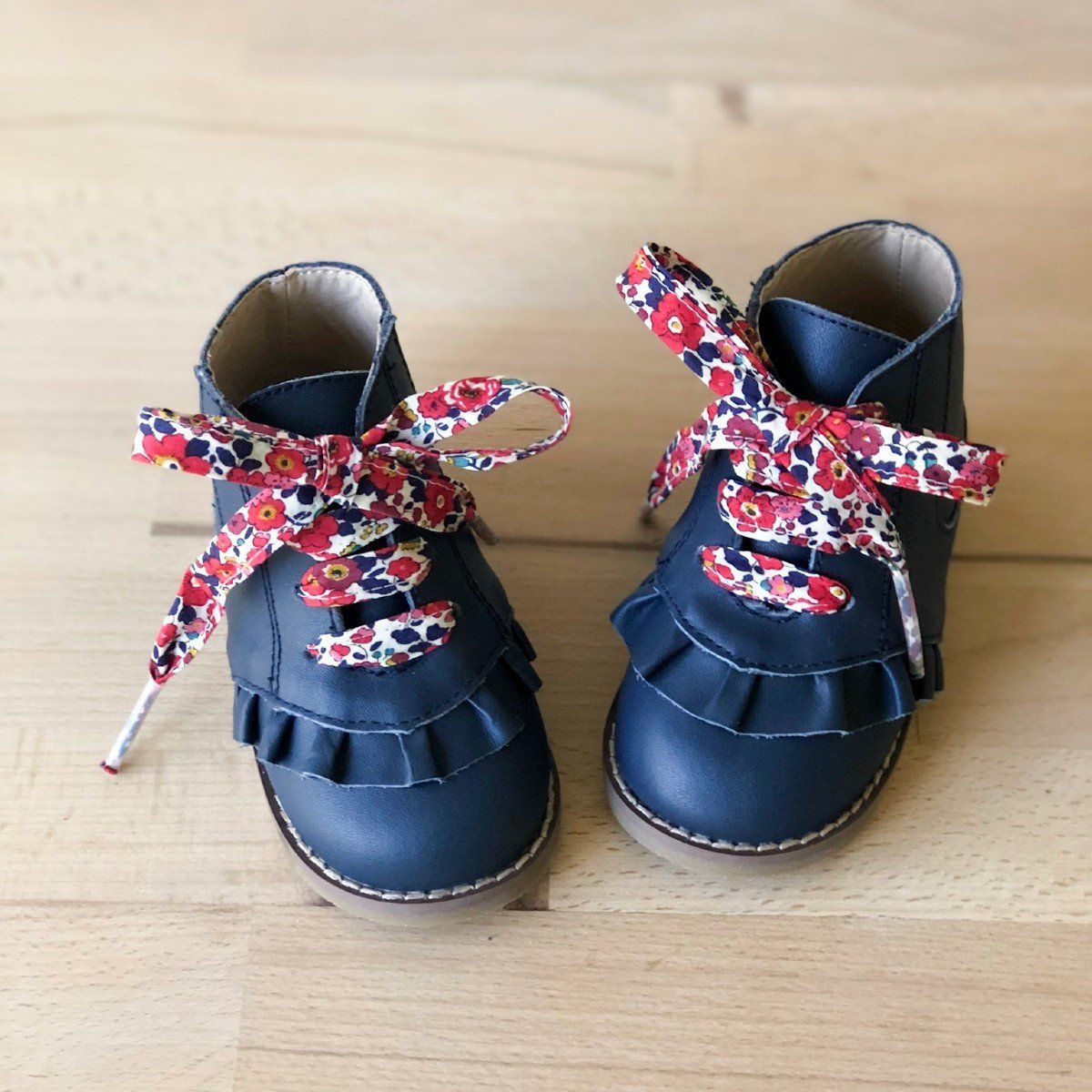 Girls navy boots with red floral shoelaces