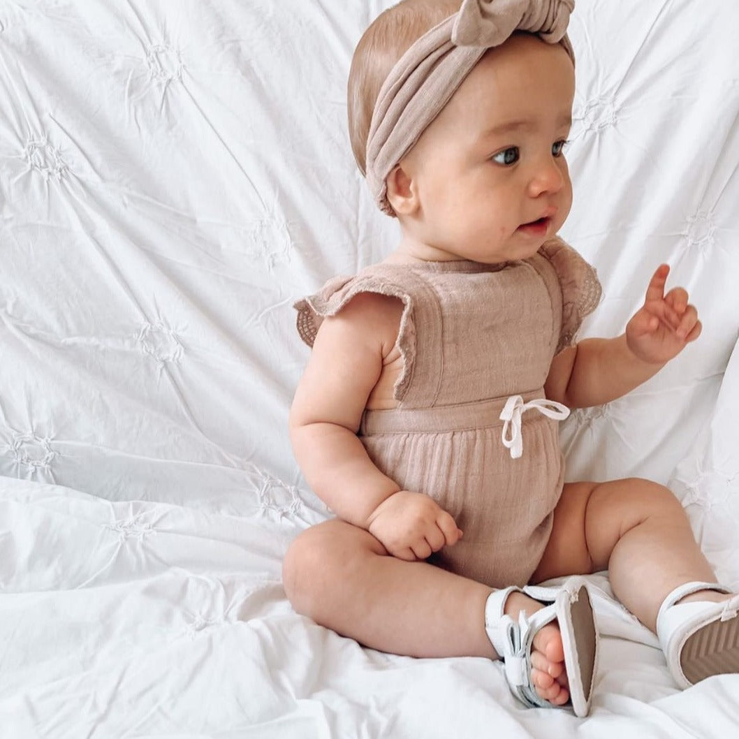 Pair of cute baby sandals on wooden background Stock Photo - Alamy